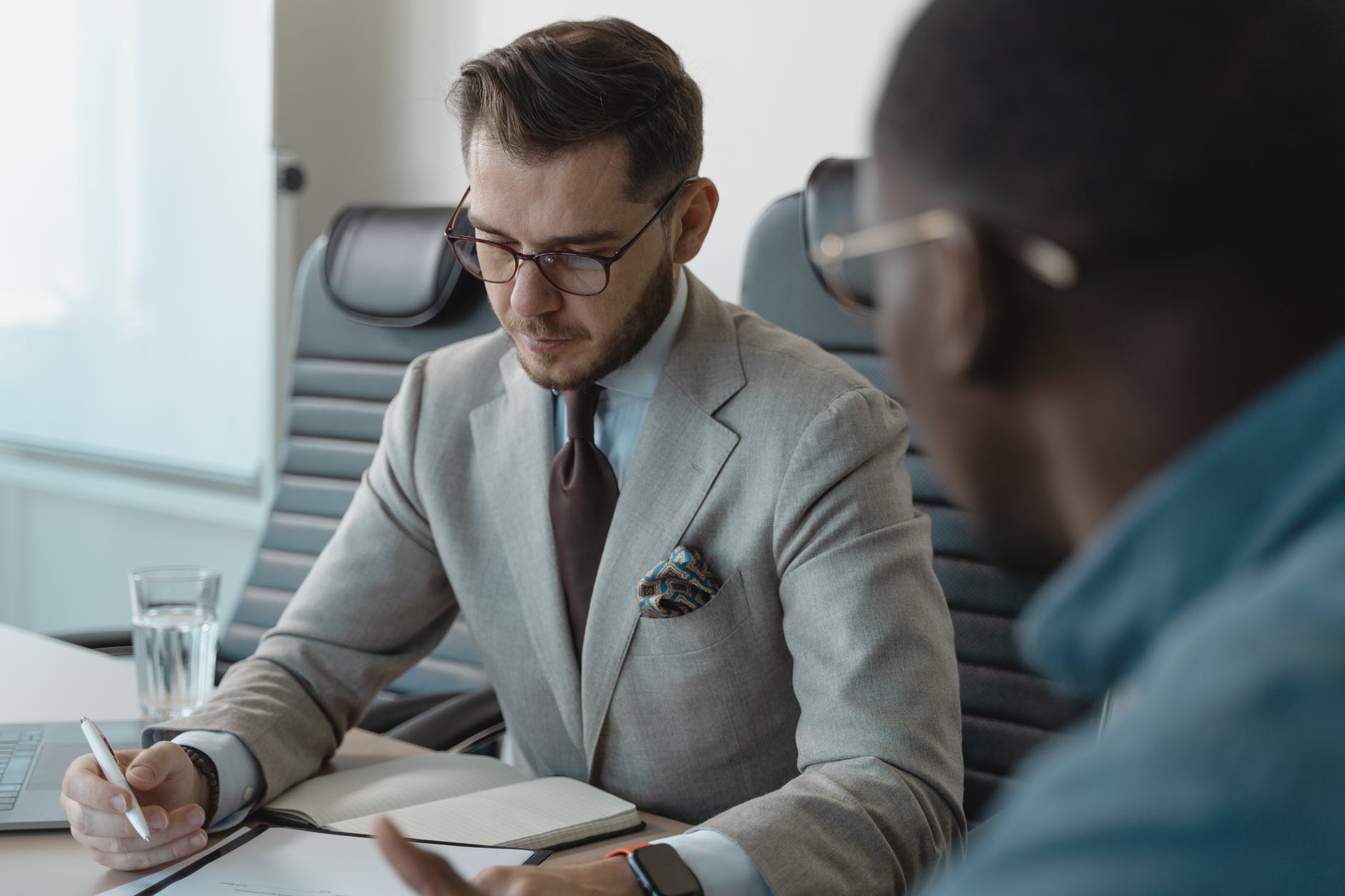 man in gray suit jacket wearing black framed eyeglasses